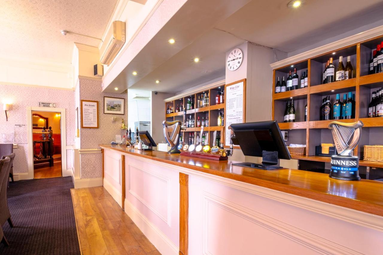 a bar in a pub with a monitor on the counter at Royal Hotel in Bath